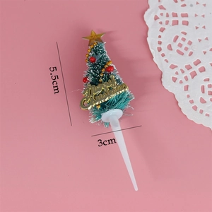 Green Christmas tree cake topper with red beads and golden Merry Christmas plaque