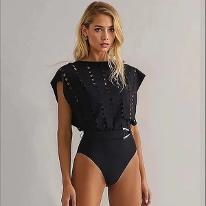 Detail of black cut-out monokini with elegant waist belt and silver buckle design