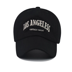 Close-up of white 3D embroidery showing LOS ANGELES on a black cotton baseball cap