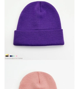 Detailed texture of purple and pink ribbed knit beanies with a fashion color chart