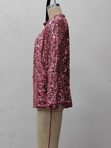 Close-up of pink sequined shirt fabric on a mannequin showcasing detailed shimmer texture