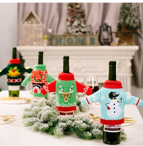 Four different festive Christmas knitted wine bottle covers with reindeer and snowman patterns