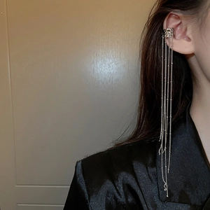 Silver fringe ear cuff featuring long hanging chains on a model's ear profile view