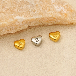 Letter A B C engraved heart pendants in 18K gold and silver stainless steel on fabric