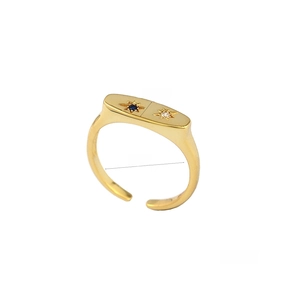 Detail view of gold eight-pointed star ring with blue and clear zircon stones