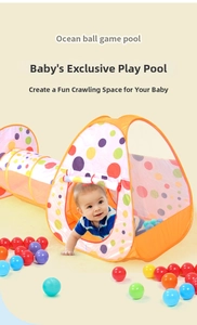 Close-up of baby crawling through a foldable 3-in-1 play tent tunnel with ocean ball pool