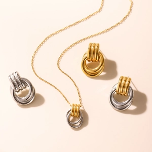Macro shot of two-tone stainless steel jewelry set with interlaced circular rings