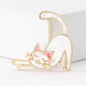 Cute white enamel cat brooch with gold edges and pink bowknot on white stand