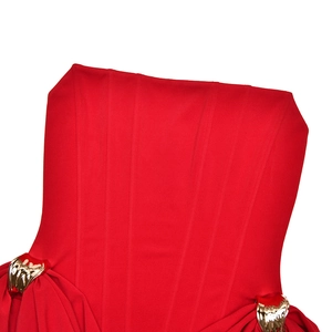 Close-up of red elegant waist dress featuring pleat details and golden metal accessories