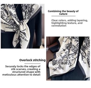 Dettaglio dell'elegante stampa floreale nera su foulard in seta con finitura orlo