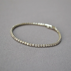 Macro shot of silver plated brass tennis bracelet featuring sparkling micro cubic zirconia