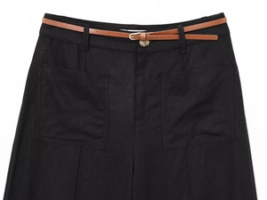 Close-up of black linen-blend wide-leg trousers featuring a brown belt and textured pockets