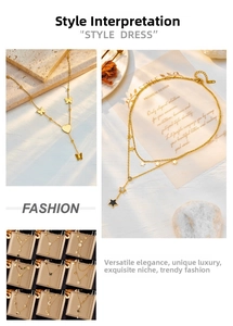 Detail of gold layered necklaces with butterfly, star, and moon charms on stone textures