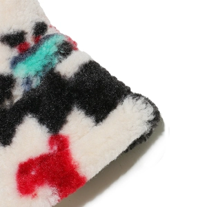 Macro texture of Bohemian faux shearling bucket hat with colorful geometric patterns