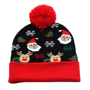 Knitted Christmas hat with red pom-pom featuring Santa and reindeer patterns