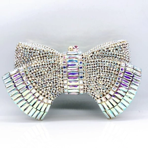 Macro shot of bow knot clutch bag featuring iridescent AB crystals and metallic frame