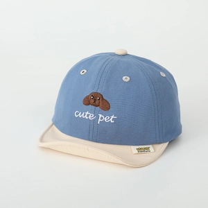 Detail of baby cotton cap featuring cute puppy embroidery and soft blue beige contrast