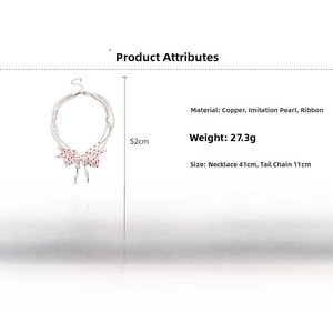 Detailed view of pink polka dot bow pearl necklace with double layer chain structure