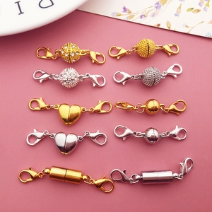 Assorted gold and silver magnetic jewelry clasps in ball, heart, and cylinder shapes
