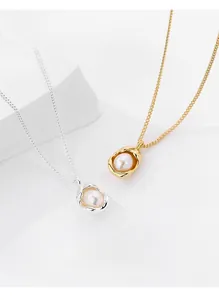 Detail of s925 silver and gold irregular lava pearl pendants on delicate cross chains