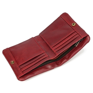 Detail view of red oil-wax leather wallet with card slots and a metal snap button closure