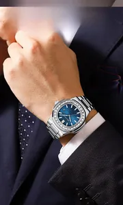 Detail of waterproof quartz watch with crystal bezel and blue dial on a suit sleeve