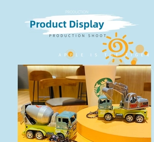 Detailed view of dinosaur excavator and mixer truck keychains with metal bells and rings