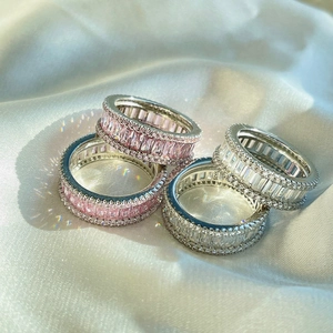 Detailed close-up of S925 silver eternity rings with pink and white baguette diamonds