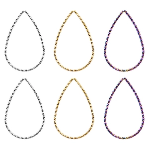 Macro view of geometric teardrop earring pendants in gold and silver finishes