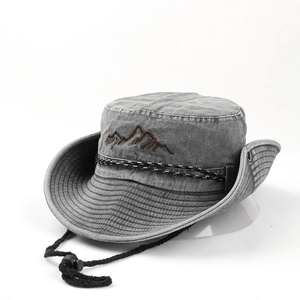Detail of dark gray cotton bucket hat featuring mountain embroidery and windproof cord