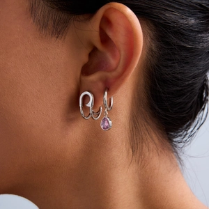 Silver stainless steel paperclip earring with pink teardrop gemstone on female ear