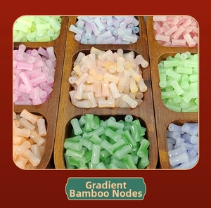 Detailed view of colorful gradient bamboo tube beads organized in a wooden display box
