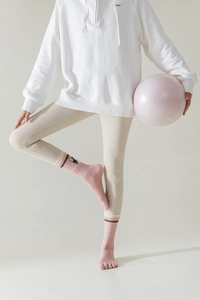 Detailed view of pink yoga toe socks with non-slip grips and cute cat pattern