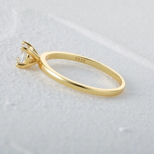 Macro view of S925 sterling silver gold ring showing four-prong square diamond setting