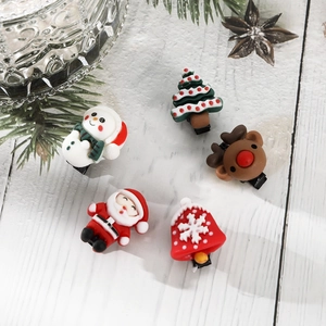 Close-up of 5-piece Christmas hair clips set with Santa, reindeer and snowman themes