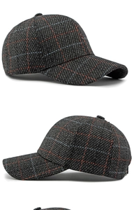 Detail of dark grey plaid baseball cap showing thick wool texture and red blue lines