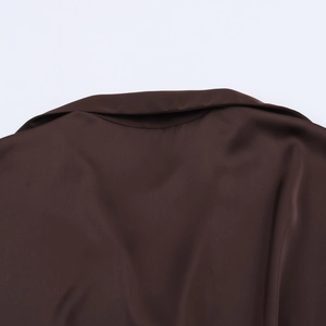 Close-up of the elegant brown satin shirt collar showing glossy fabric texture and detail