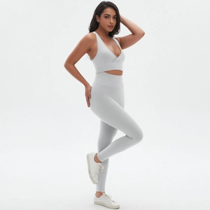Close-up of light grey seamless yoga set featuring cross-back sports bra and high-waist leggings