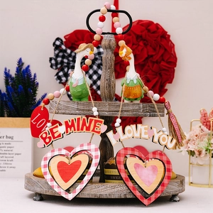 Dettaglio dei ciondoli a cuore in legno a quadretti rosso-bianchi e segno Be Mine