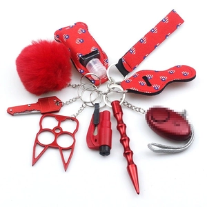 Macro shot of red neoprene personal safety keychain kit with plush ball and wristlet strap