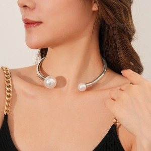 Detail of silver spiral choker featuring large and small pearls on model neckline