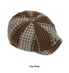 Top view of vintage patchwork newsboy cap with brown stripes and blue plaid fabric detail