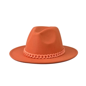 Detail of the orange wool fedora featuring a matching chunky chain hatband decoration