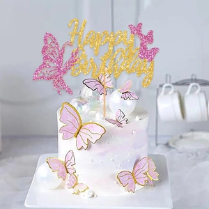 Pink and gold Happy Birthday cake topper set with butterfly decorations on a cake