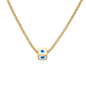 Detailed macro view of gold evil eye cube pendant necklace with blue enamel motifs