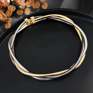 Detail of twisted multi-strand metallic coil necklace in gold and silver finish