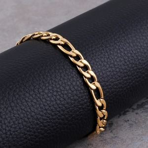 Polished gold Figaro link chain for men in premium stainless steel on a display