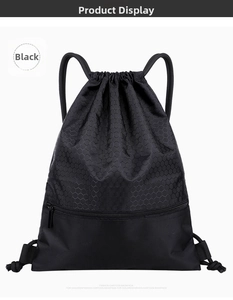 Detail of black nylon drawstring bag showing honeycomb texture and hidden zipper pocket