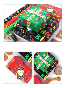 Detail showing assorted birthday wrapping paper rolls with colorful letters and ribbons