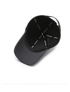 Detailed inner view of black baseball cap showing logo taping and reinforced stitching